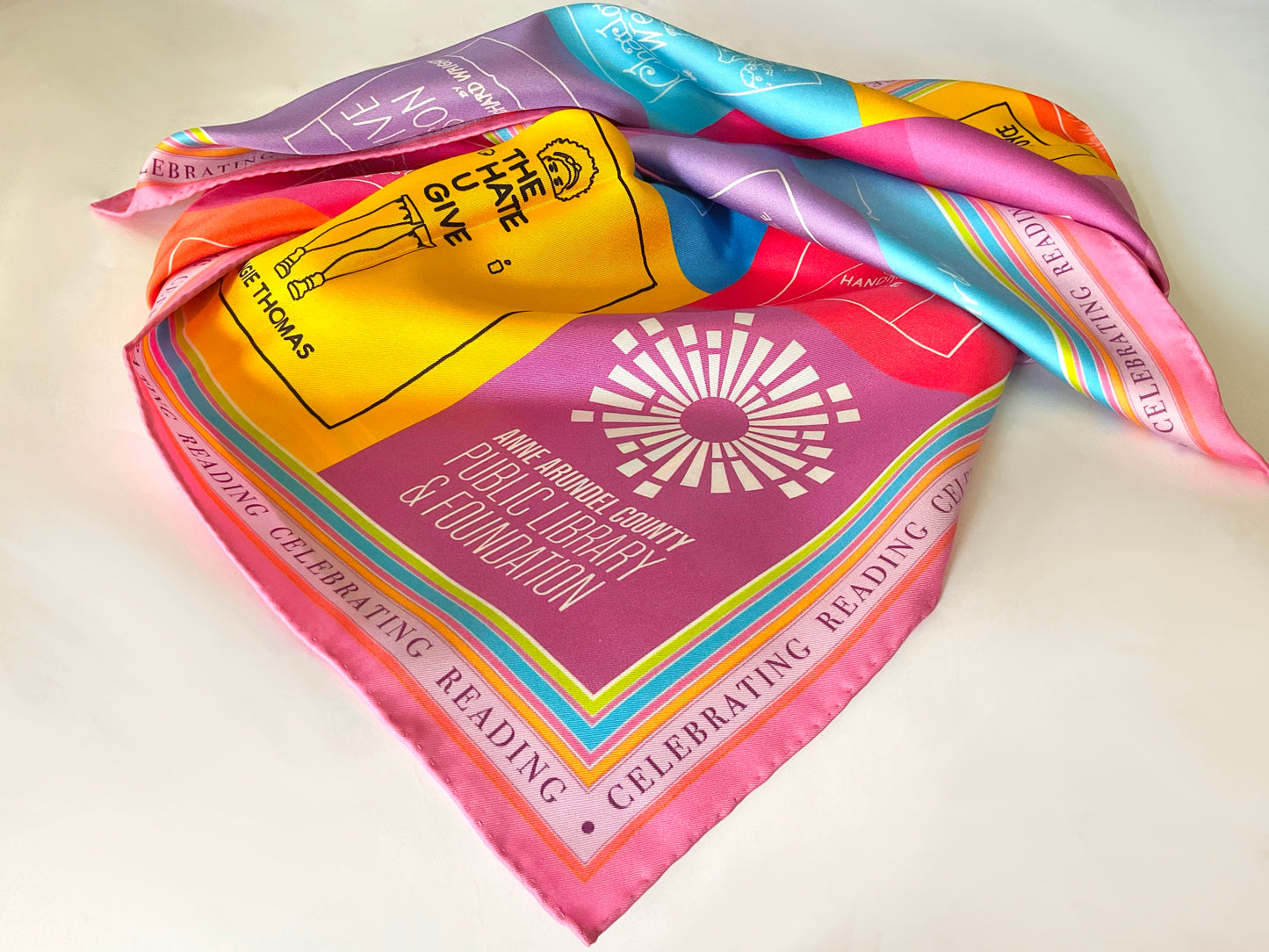 This colorful upbeat scarf celebrates reading with a depiction of 30 classic books illustrated with simplified line on bright fields of color. Scarf dimensions: 36” square.